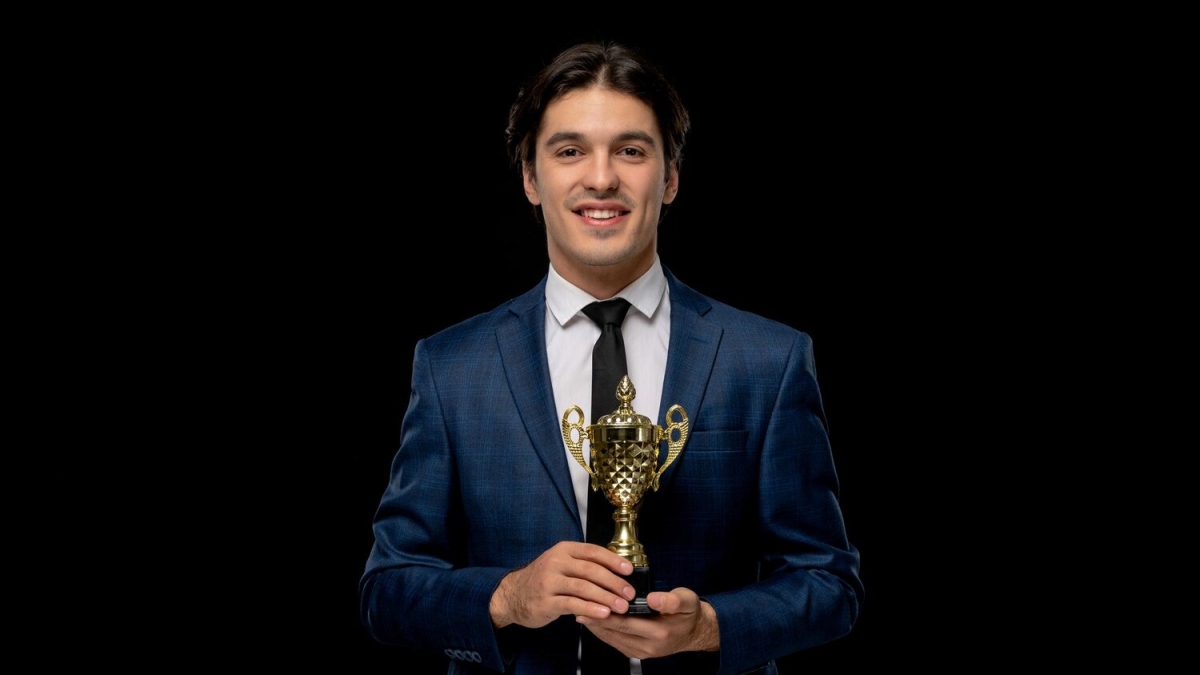 business-man-smart-handsome-guy-dark-blue-suit-with-tie-holding-golden-trophy_140725-161998